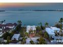 Waterfront home aerial view showcasing meticulous landscaping and picturesque water views at 679 Norsota Way, Sarasota, FL 34242