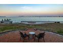 Outdoor patio with seating area overlooking waterfront view at 679 Norsota Way, Sarasota, FL 34242