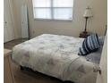 Bedroom featuring a plush bed, wood floors, a mirror, and window at 7211 W Country Club N Dr # 135, Sarasota, FL 34243
