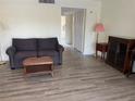 Neutral living room with hard surface flooring, a plush sofa, and side tables at 7211 W Country Club N Dr # 135, Sarasota, FL 34243