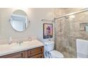 Bathroom featuring neutral tile in the glass enclosed shower, a wood vanity, and new fixtures at 805 Spring Lakes Blvd # 805, Bradenton, FL 34210