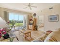 Bright living room with golf course view and sliding door access to lanai at 8735 Olde Hickory Ave # 8210, Sarasota, FL 34238
