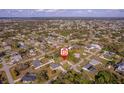 Wide aerial shot of the neighborhood, highlighting community layout and nearby residential properties at 1124 Ample Ave, Port Charlotte, FL 33948