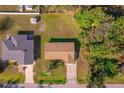 Aerial view of the property showcasing the house with brown roof, backyard, and surrounding neighborhood at 1124 Ample Ave, Port Charlotte, FL 33948