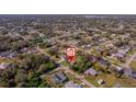 An aerial view showing the property's location within a residential neighborhood with lush greenery at 1124 Ample Ave, Port Charlotte, FL 33948