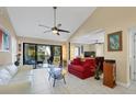 Bright living room with tile floors, modern furnishings, and a sliding glass door to patio at 1617 Brookhouse Dr # 255, Sarasota, FL 34231