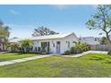 Charming home with a manicured front yard, lush green grass, and fresh landscaping at 2202 Waldemere St, Sarasota, FL 34239