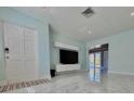 Bright living room with glossy marble floors, modern lighting, and an entertainment center at 2785 Sydelle St, Sarasota, FL 34237