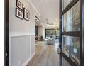 Inviting entryway showcasing wood floors, a modern door, and a view into the living area at 2823 Marshall Dr, Sarasota, FL 34239