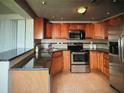 Well-equipped kitchen with stainless steel appliances, dark countertops, and tiled backsplash, perfect for cooking at 3060 Arrowhead Rd, Venice, FL 34293