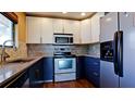 Modern eat-in kitchen featuring stainless steel appliances and stylish two-tone cabinets at 3500 El Conquistador Pkwy # 336, Bradenton, FL 34210