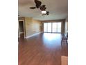 Spacious living room featuring wood floors, recessed lighting, and sliding glass doors at 3500 El Conquistador Pkwy # 336, Bradenton, FL 34210