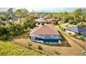 The aerial view showcases a screened-in pool and the home's beautiful backyard at 4396 Everglades Ter, North Port, FL 34286