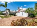 Well maintained home exterior featuring a two car garage, brick driveway and mature landscaping at 538 Fallbrook Dr, Venice, FL 34292