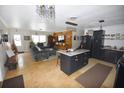 Open-concept living room with a kitchen island, tile flooring, and a comfortable sofa at 5419 1St W Ave, Bradenton, FL 34209