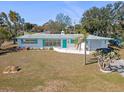 Inviting single-story home featuring a well-manicured lawn, turquoise trim, and attached garage at 5724 25Th W St, Bradenton, FL 34207