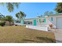 Beautiful single-story home with turquoise trim, a well-kept lawn, and a bright, welcoming facade at 5724 25Th W St, Bradenton, FL 34207