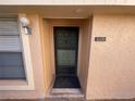 Close-up of the front door of a condo with visible house number at 6330 7Th W Ave, Bradenton, FL 34209