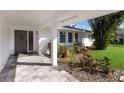 Inviting front porch with stone pavers and lush tropical landscaping leading to the front door at 7204 18Th W Ave, Bradenton, FL 34209