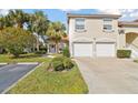 Townhouse with two-car garage, lovely lawn, and tropical palm tree at 7232 Cedar Hollow Cir # 7232, Bradenton, FL 34203