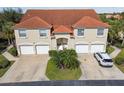 Two-story townhouse with dual garage, red tile roof, and well-maintained landscaping at 7232 Cedar Hollow Cir # 7232, Bradenton, FL 34203