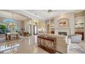 Bright and airy living room with fireplace, elegant furniture, and marble floors at 7303 Westminster Ct, University Park, FL 34201