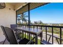 Screened balcony featuring views of the beach, Intracoastal and updated outdoor furniture at 901 Beach Rd # 402, Sarasota, FL 34242