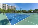 Well-maintained tennis courts with condo building backdrop at 1105 Gulf Of Mexico Dr # 603, Longboat Key, FL 34228