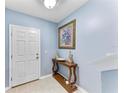 Inviting entryway with light blue walls, tiled flooring and a decorative console table at 1122 42Nd E Ter, Bradenton, FL 34208