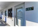 Close-up of unit 1517's front door with textured wall and covered walkway at 1517 Pleasant Rd # A22, Bradenton, FL 34207