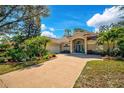 Lovely single Gathering home featuring mature landscaping, a side entry garage, and a long driveway at 2081 Timucua Trl, Nokomis, FL 34275