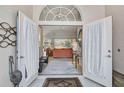 View through foyer into living room featuring neutral paint and an outdoor view at 2081 Timucua Trl, Nokomis, FL 34275