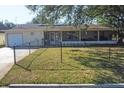 Charming single-story home with a large screened in porch and fenced front yard at 2202 21St W St, Bradenton, FL 34205