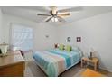 Bright bedroom with a colorful bedspread, a large window with sheer curtains, and ample natural light at 3863 59Th W Ave # 4189, Bradenton, FL 34210