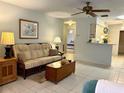 Bright living room has tile floors, ceiling fan and a view into the kitchen and breakfast nook at 4197 66Th Street W Cir, Bradenton, FL 34209