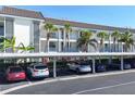 Condominium exterior with well-kept carport and colorful landscaping at 4310 Falmouth Dr # 102, Longboat Key, FL 34228