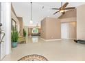 Spacious foyer featuring high ceilings, tile floors, and view of the living room with lots of natural light at 4540 Maverick St, North Port, FL 34288