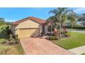 Beautiful single-story home with a brick drive, well manicured landscaping, and a two-car garage at 4802 68Th Street E Cir, Bradenton, FL 34203