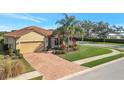 Beautiful single-story home with a brick drive, well manicured landscaping, and a two-car garage at 4802 68Th Street E Cir, Bradenton, FL 34203