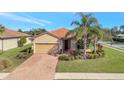 Charming single-story home featuring a tile roof, two-car garage, and well-manicured landscaping at 4802 68Th Street E Cir, Bradenton, FL 34203