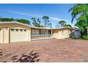 Inviting single-story home featuring a spacious brick driveway and a well-maintained front yard at 507 67Th W Ave, Bradenton, FL 34207