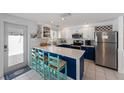 Bright modern kitchen featuring white countertops, stainless steel appliances, and stylish blue and white cabinetry at 5807 De Palmas Ave, Holmes Beach, FL 34217