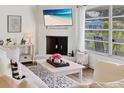 Cozy living room showcasing a white brick fireplace, a large window, and comfortable decor at 6624 Fairway Dr, Sarasota, FL 34243