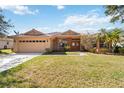 Charming single-story home with a well-manicured lawn, a two-car garage, and a welcoming front entrance at 6637 Deering Cir, Sarasota, FL 34240