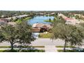 Beautiful front exterior with a red tile roof and lush trees creating a sense of privacy and curb appeal at 6637 Deering Cir, Sarasota, FL 34240