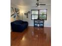 Bright living room featuring hardwood floors, a ceiling fan, and modern decor at 7109 Java Dr, Sarasota, FL 34241