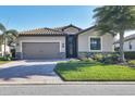 Attractive single-story home featuring a tile roof, two-car garage, and well-maintained lawn at 7140 Marsh View Ter, Bradenton, FL 34212