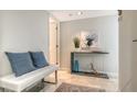 Light and bright entryway featuring a console table, artwork, and a bench at 775 Longboat Club Rd # 406, Longboat Key, FL 34228