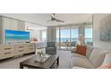 Light-filled living room featuring a view of the bedroom and an ocean view at 775 Longboat Club Rd # 406, Longboat Key, FL 34228