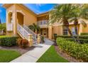 Inviting condo exterior with a private balcony, well-maintained landscape, and sunny skies at 8414 Wethersfield Run # 102, Lakewood Ranch, FL 34202